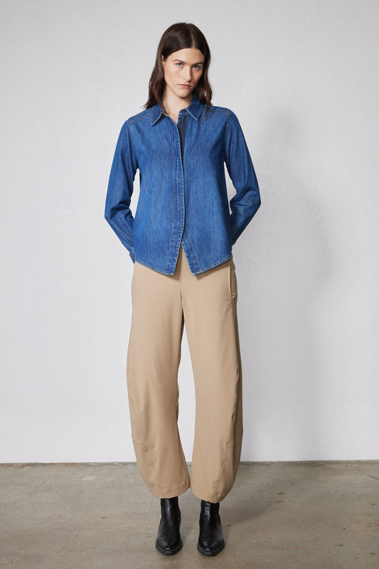 Medium-wash denim zip-front blouse with stand collar and long sleeves, front view