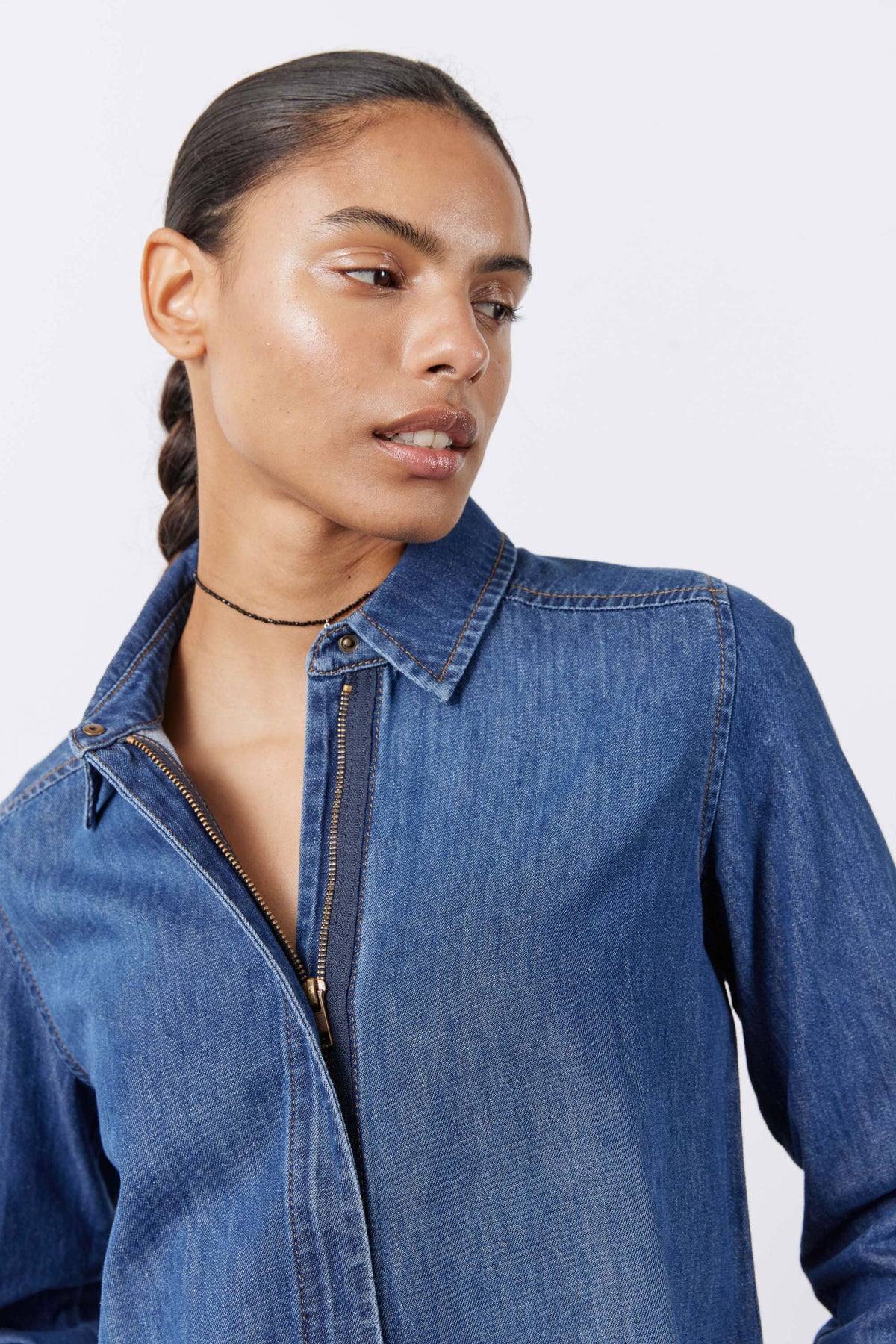 Medium-wash denim blouse with point collar and front zipper placket