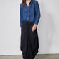 Medium-wash denim shirt with point collar, button front, and long sleeves