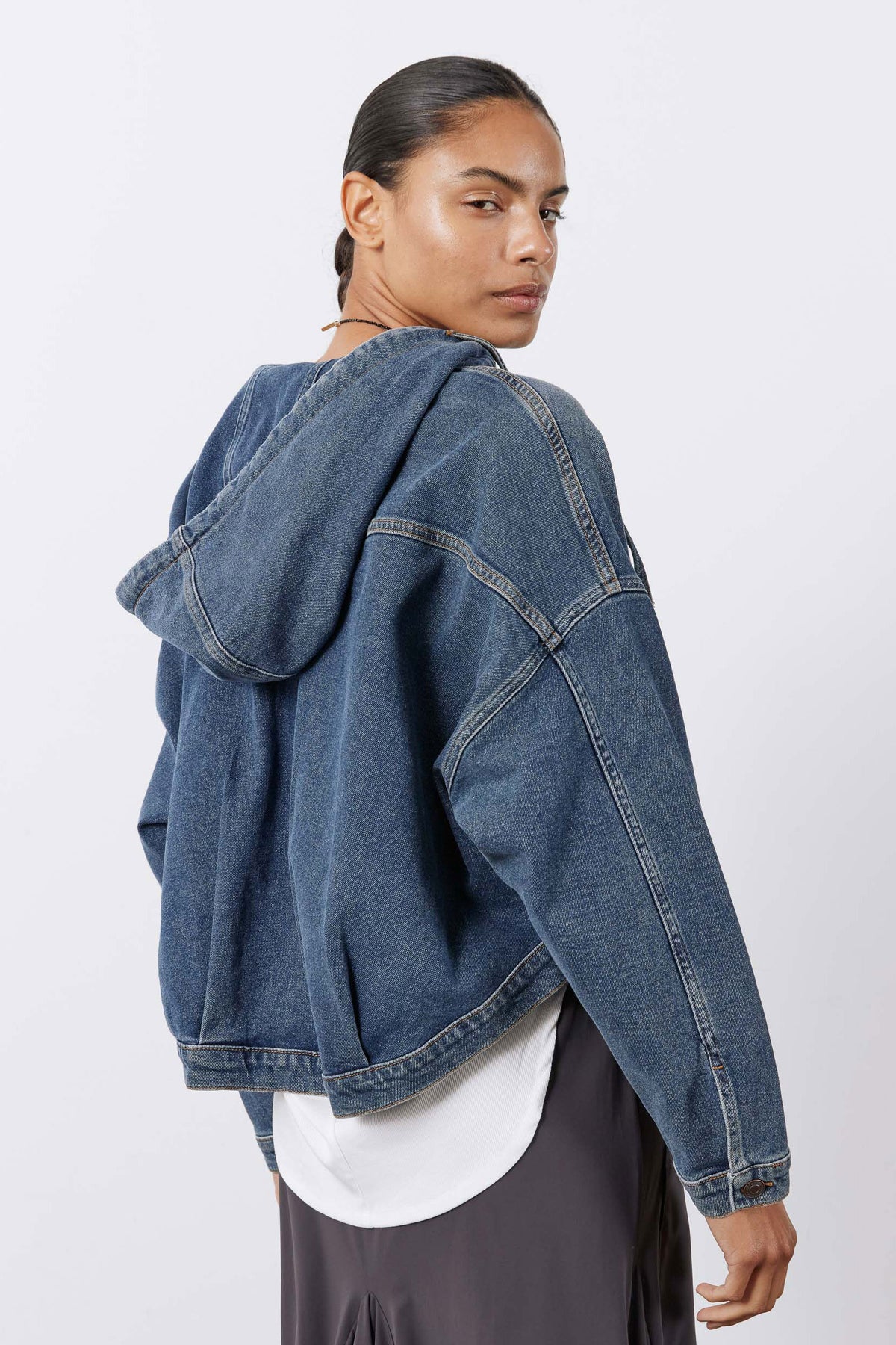 Washed denim jacket with oversized hood, button cuffs, shoulder yoke detail