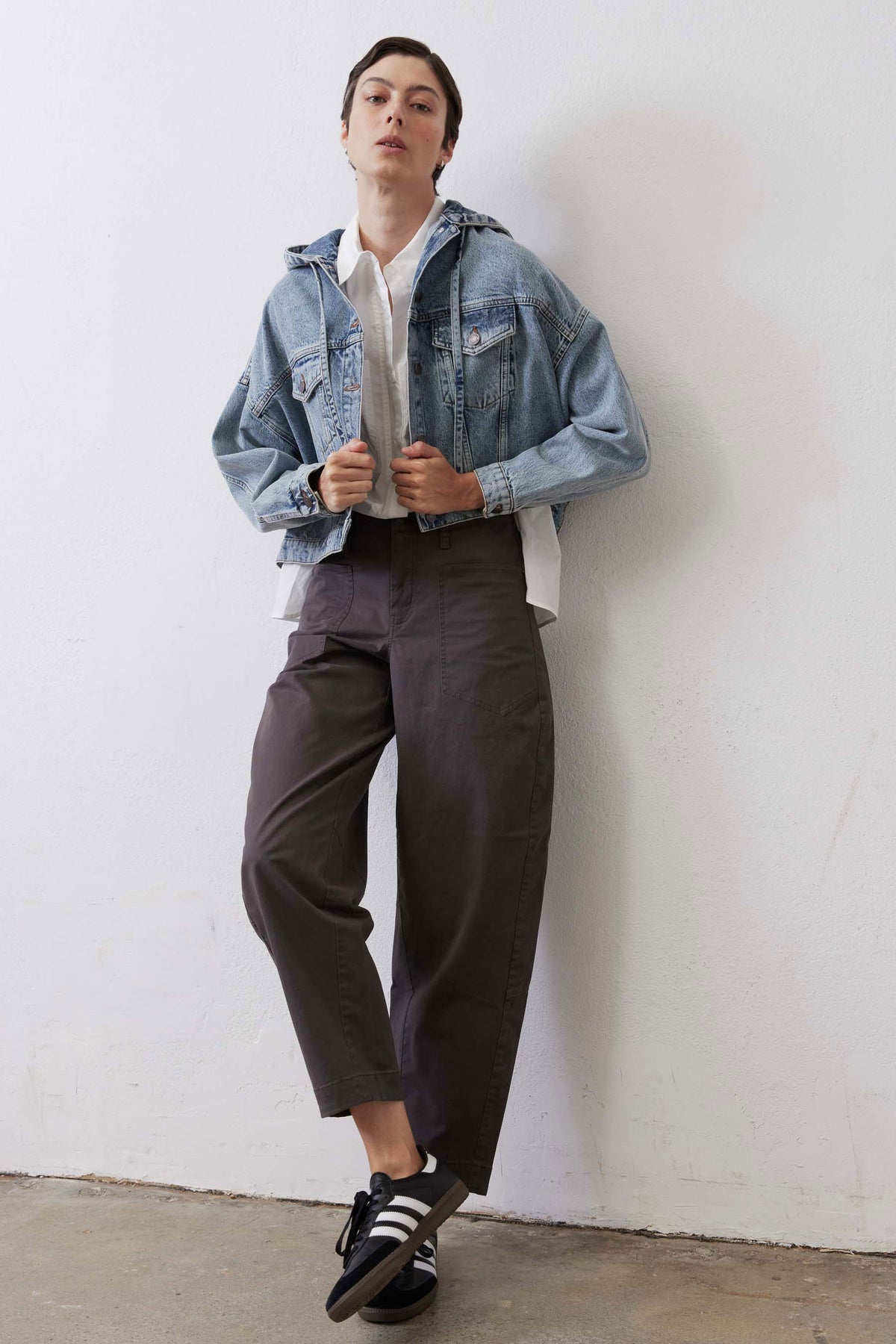 Washed blue denim jacket with button front, chest pockets, and folded cuffs