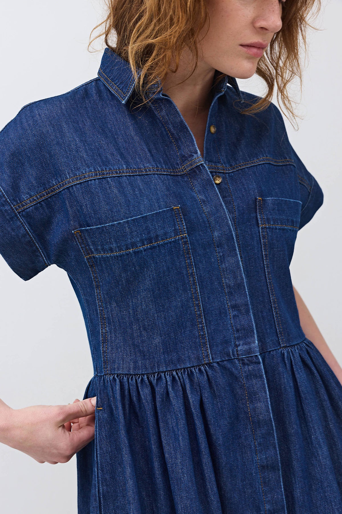 Denim shirt dress detail: front buttons, chest pockets, gathered skirt waist