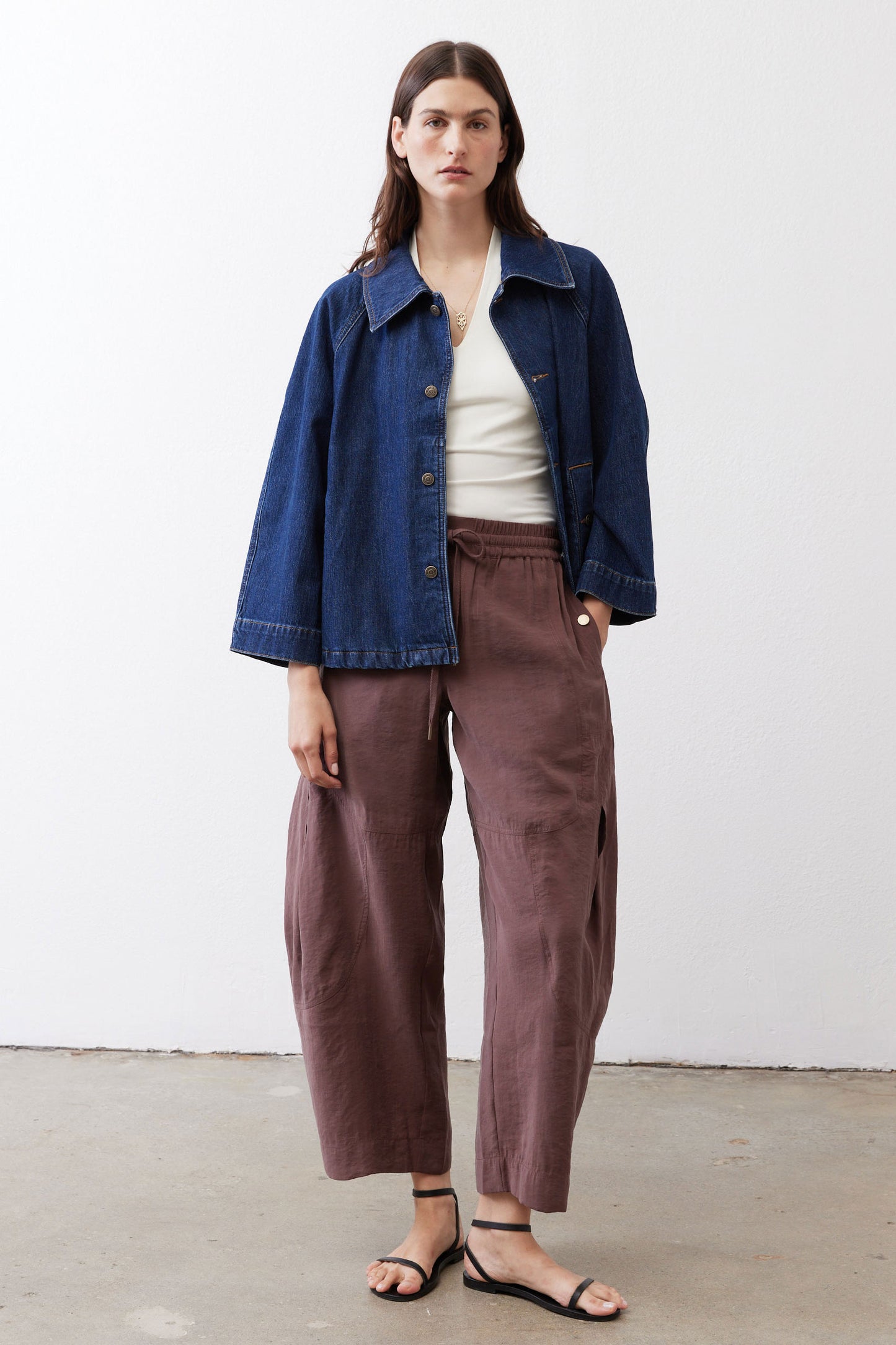 Denim cropped swing jacket in medium wash with chest patch pockets and button-front