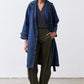 Dark blue denim trench coat with notched lapel and double-breasted button closure