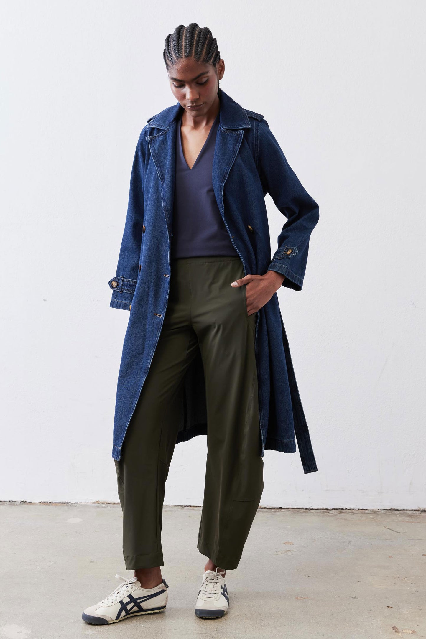 Dark blue denim trench coat with gold-tone buttons and belted waist, open front