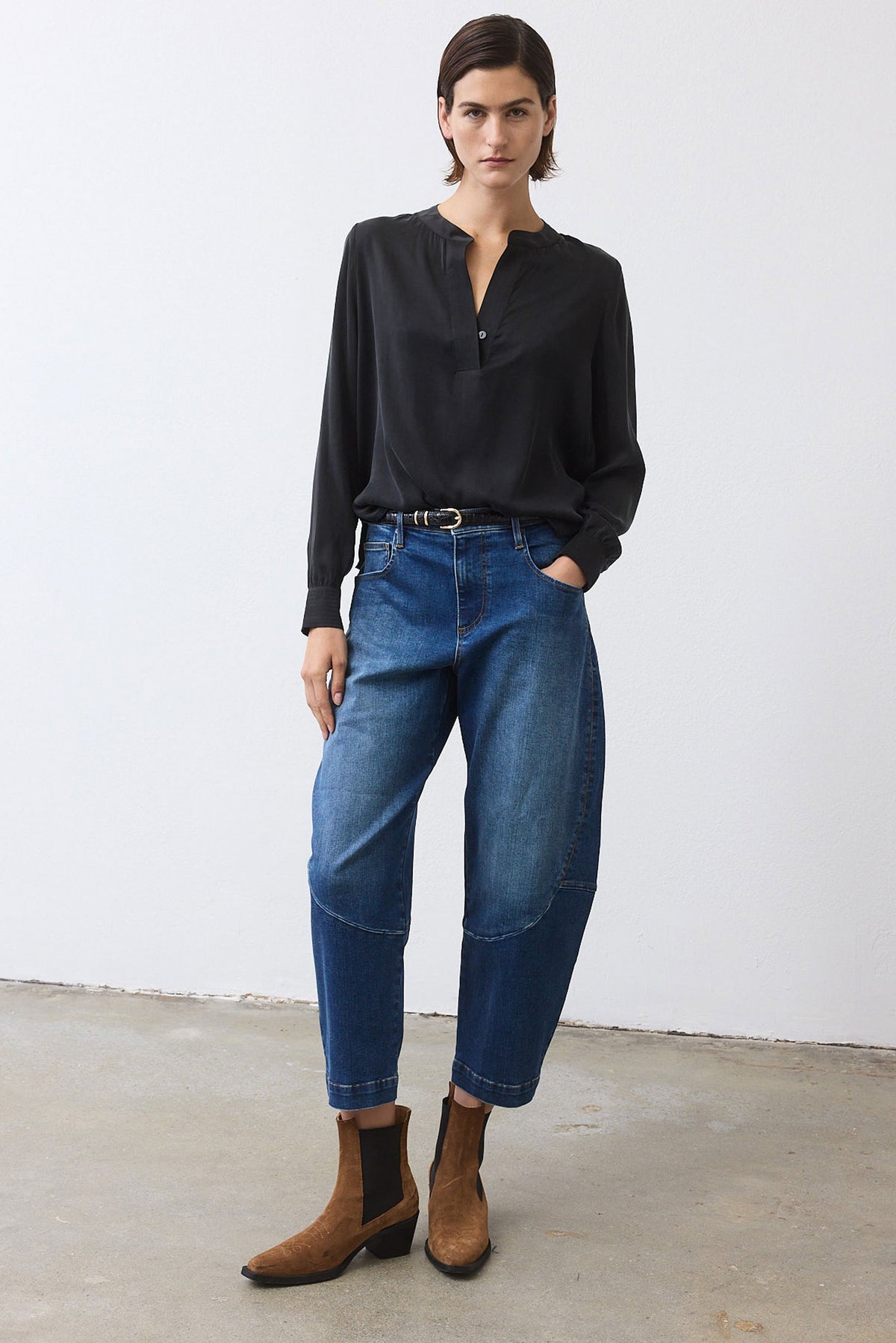 Medium-wash denim wide-leg pants with belt loops and stitched seams