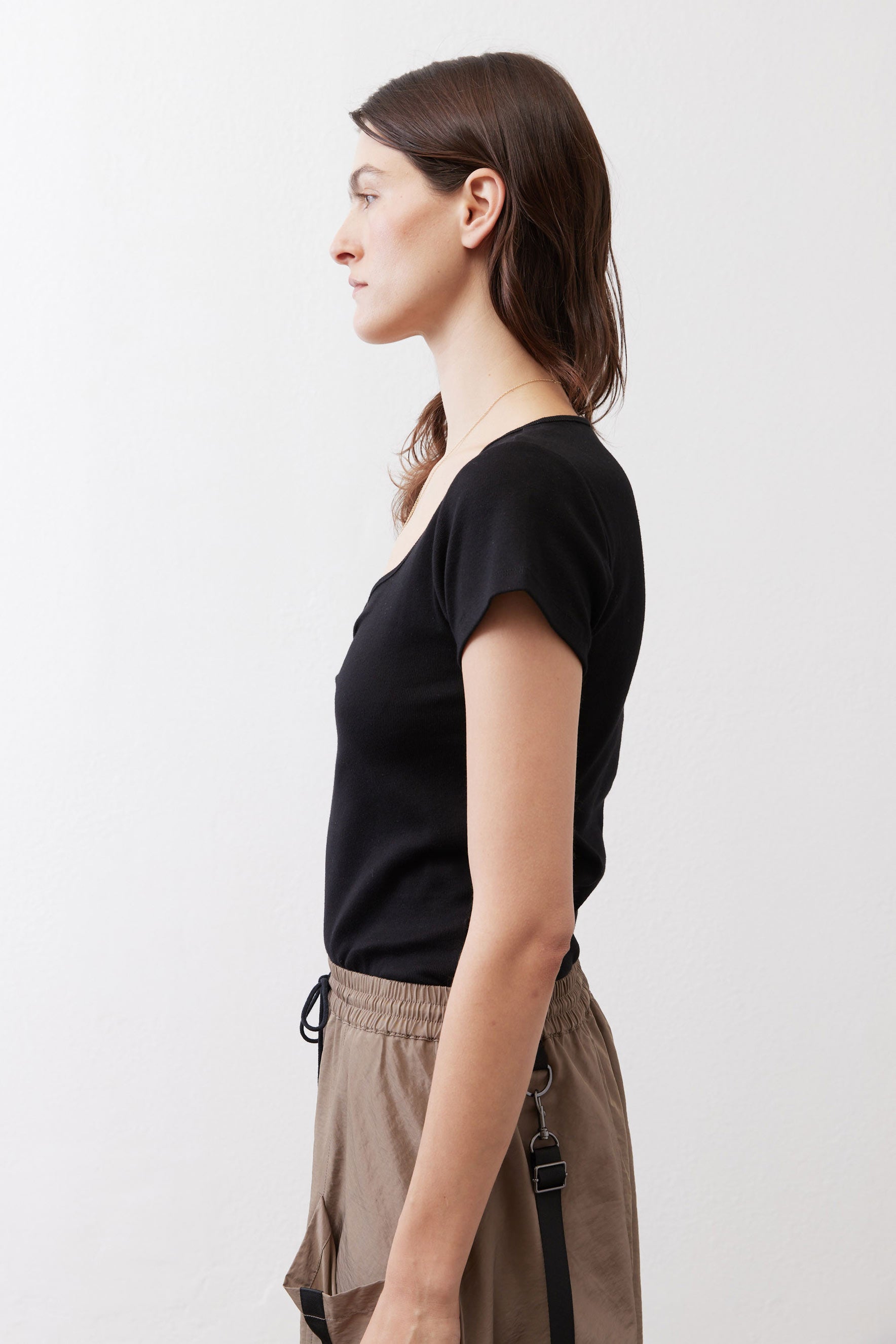 Black short-sleeve top with square neckline and ruched front, side view