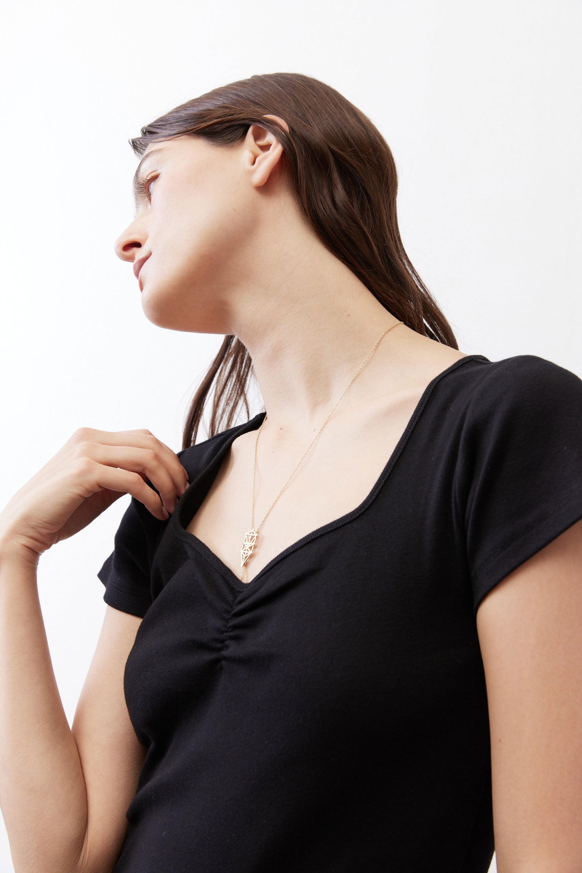 Black square-neck top with ruched neckline, close-up
