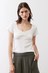 Ivory short-sleeve top with dipped neckline and subtle center ruching
