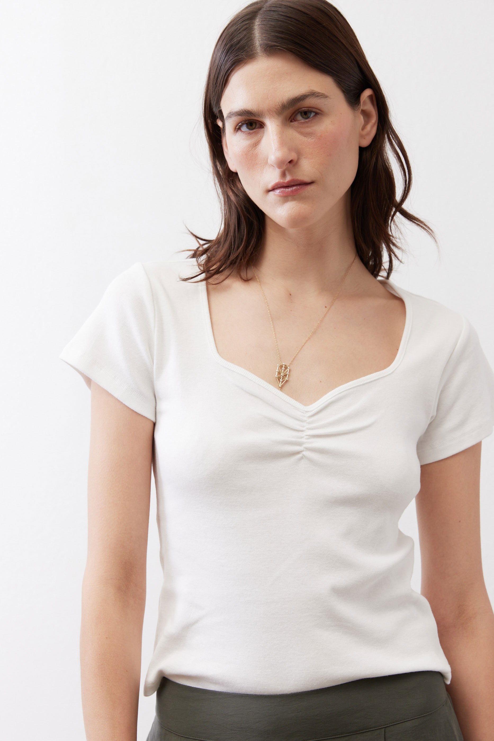 Ivory square-neck dipped top with short sleeves and V-shaped gathered bust detail