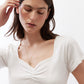 Ivory square-neck dipped top with ruched V-shaped center and short sleeves