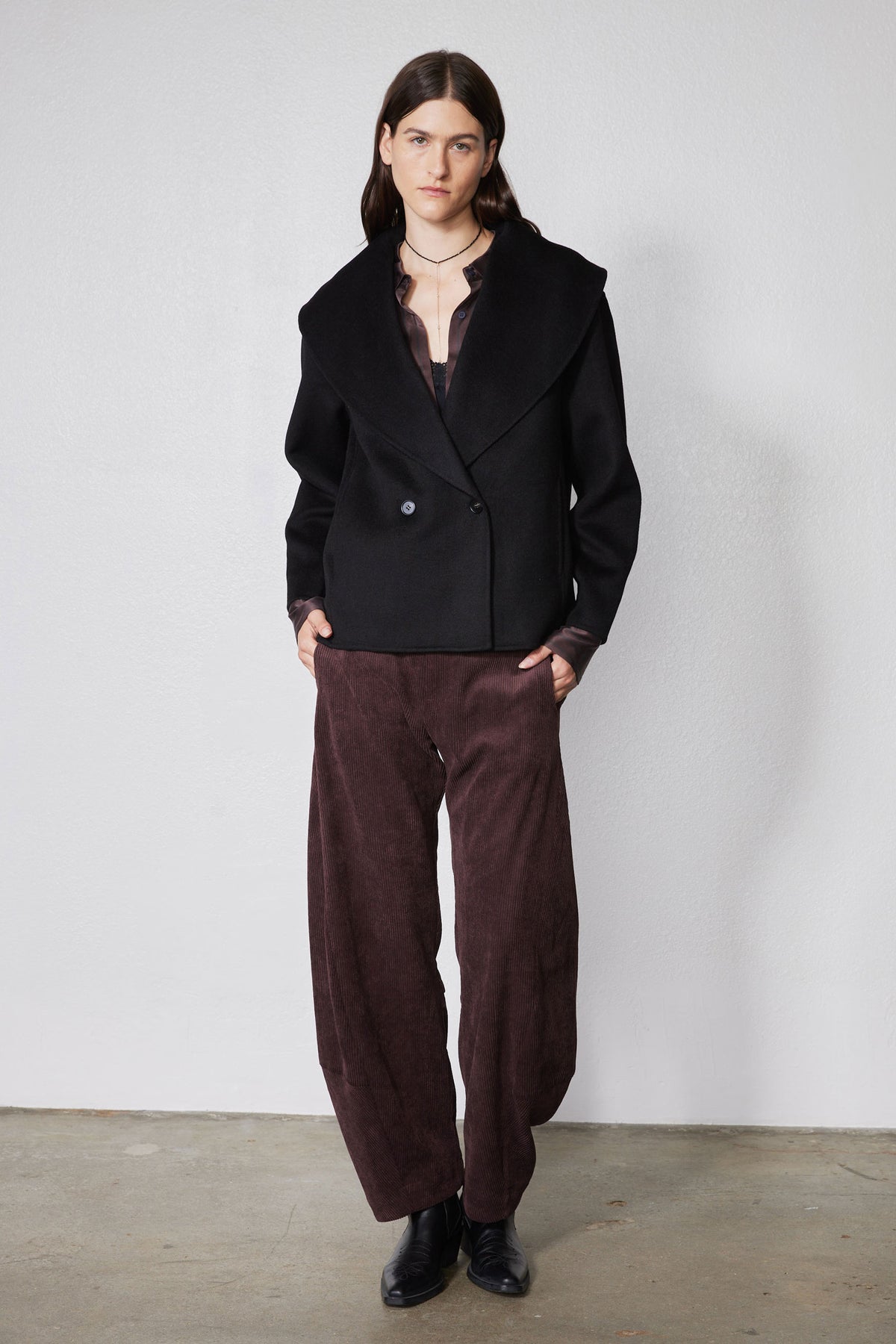 Black cropped wool coat with notch lapels and two-button double-breasted closure