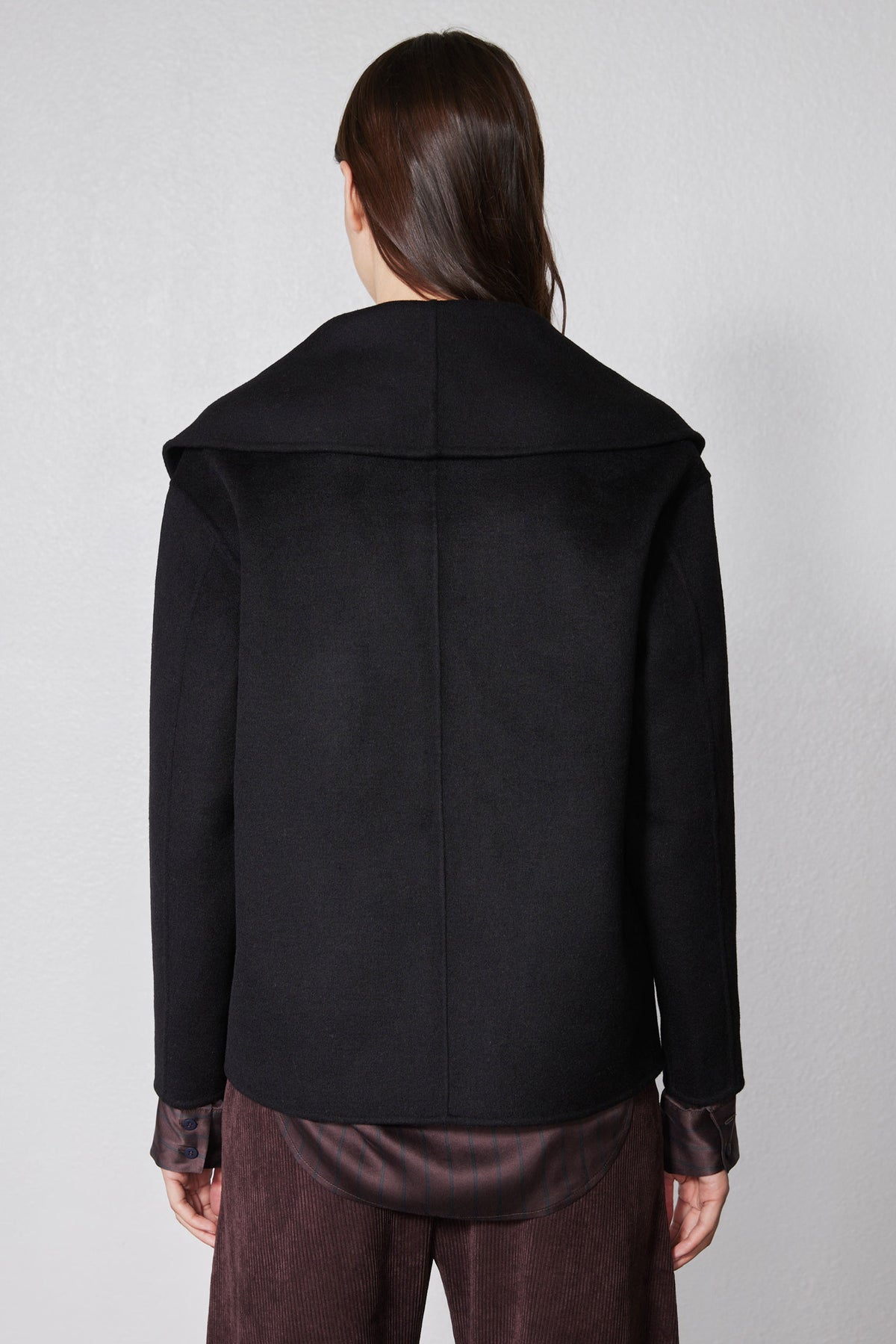 Black cropped wool coat back view with shoulder yoke seam and smooth finish