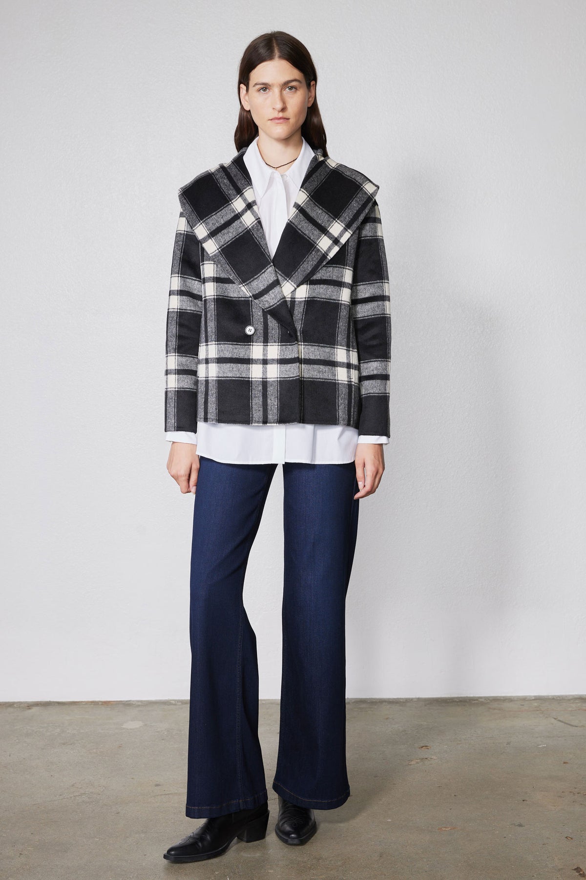 Cropped wool coat in black and white plaid with notched lapels and button front