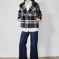 Cropped plaid wool coat with long sleeves, patch pockets, and button front, black/white