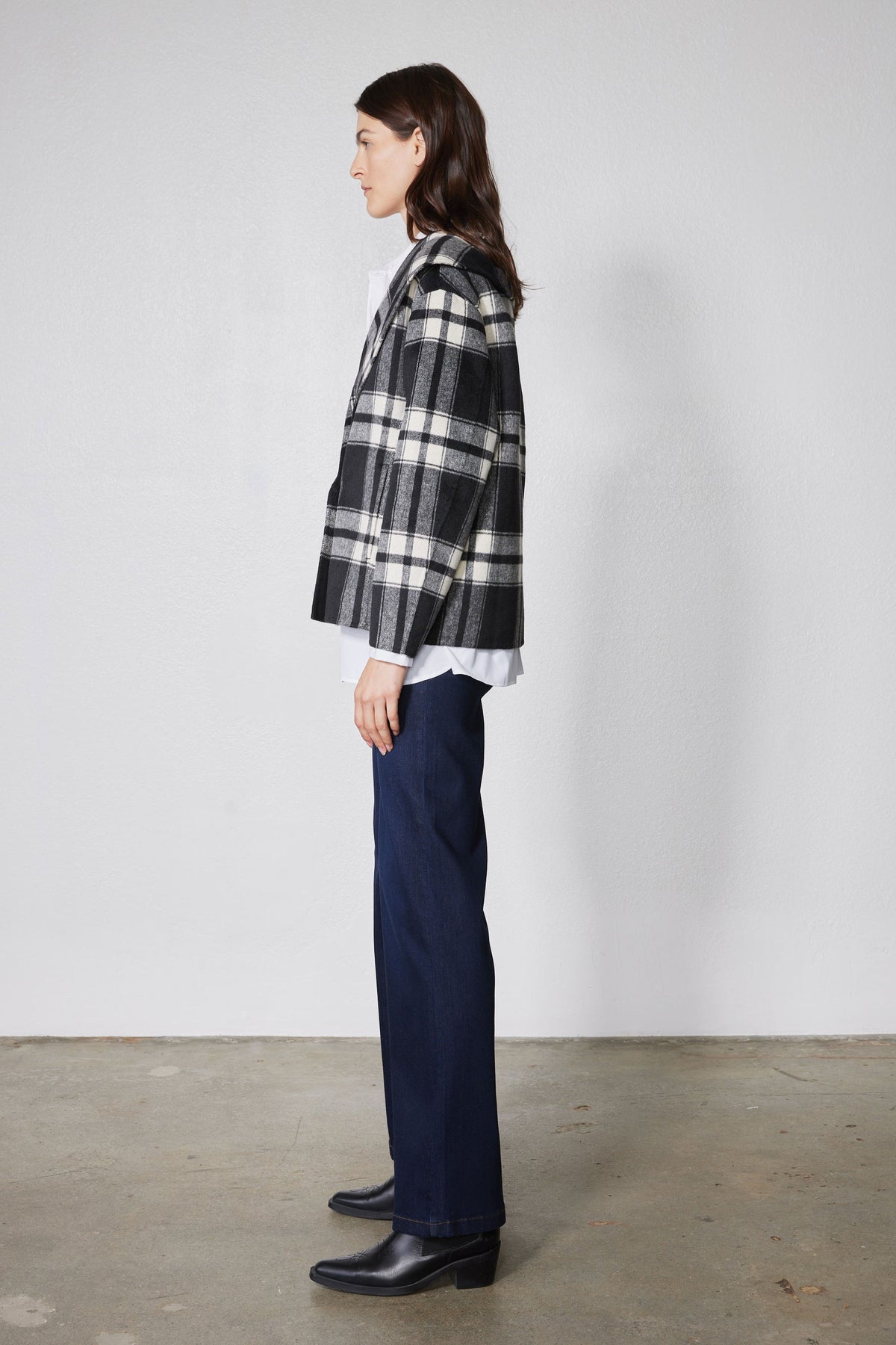 Cropped plaid wool coat side view in black and white checks with button front
