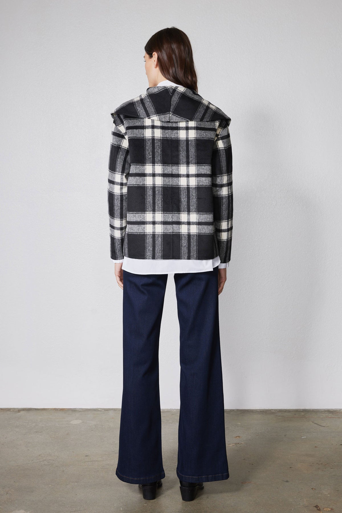 Cropped wool coat back view in black and white plaid with yoke and button closures