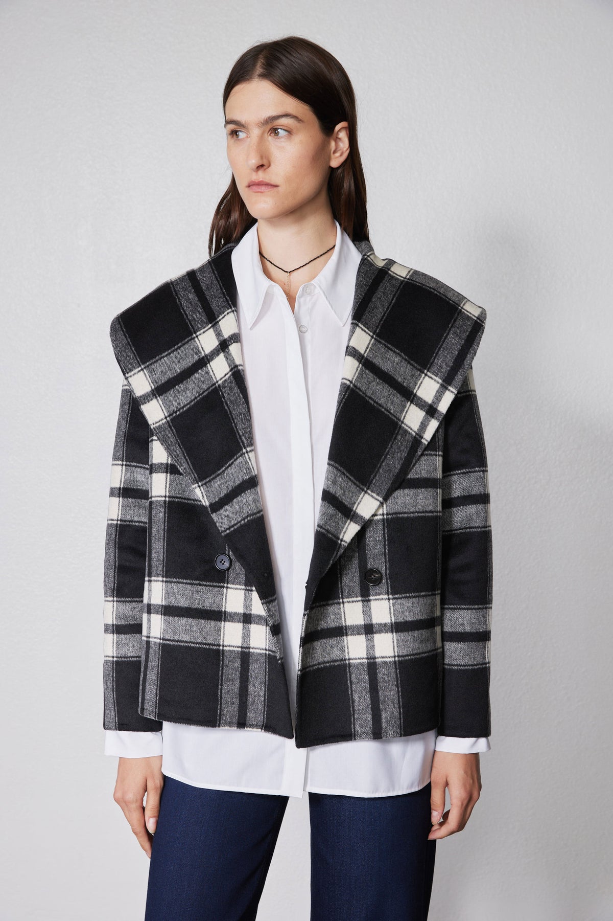Cropped plaid wool coat with notched lapels, dark buttons, and structured shoulders