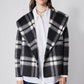 Cropped double-faced wool coat in black and white plaid, front view with button closure
