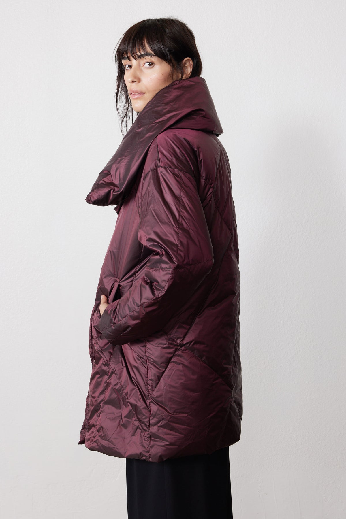Side view of the mulberry puffer jacket, showing its long cut and oversized collar