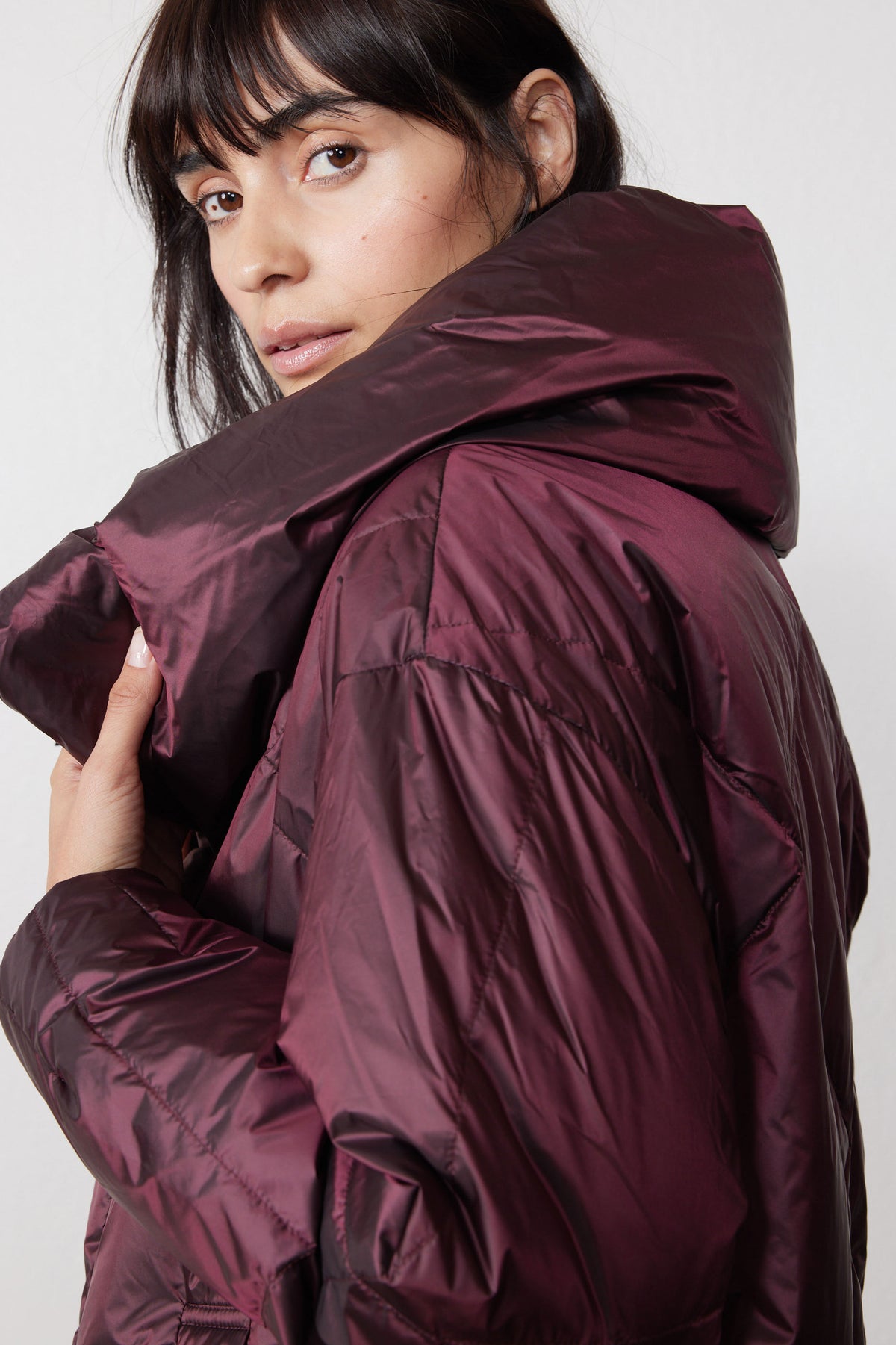 Close-up of the jacket's glossy quilted sleeve and oversized collar