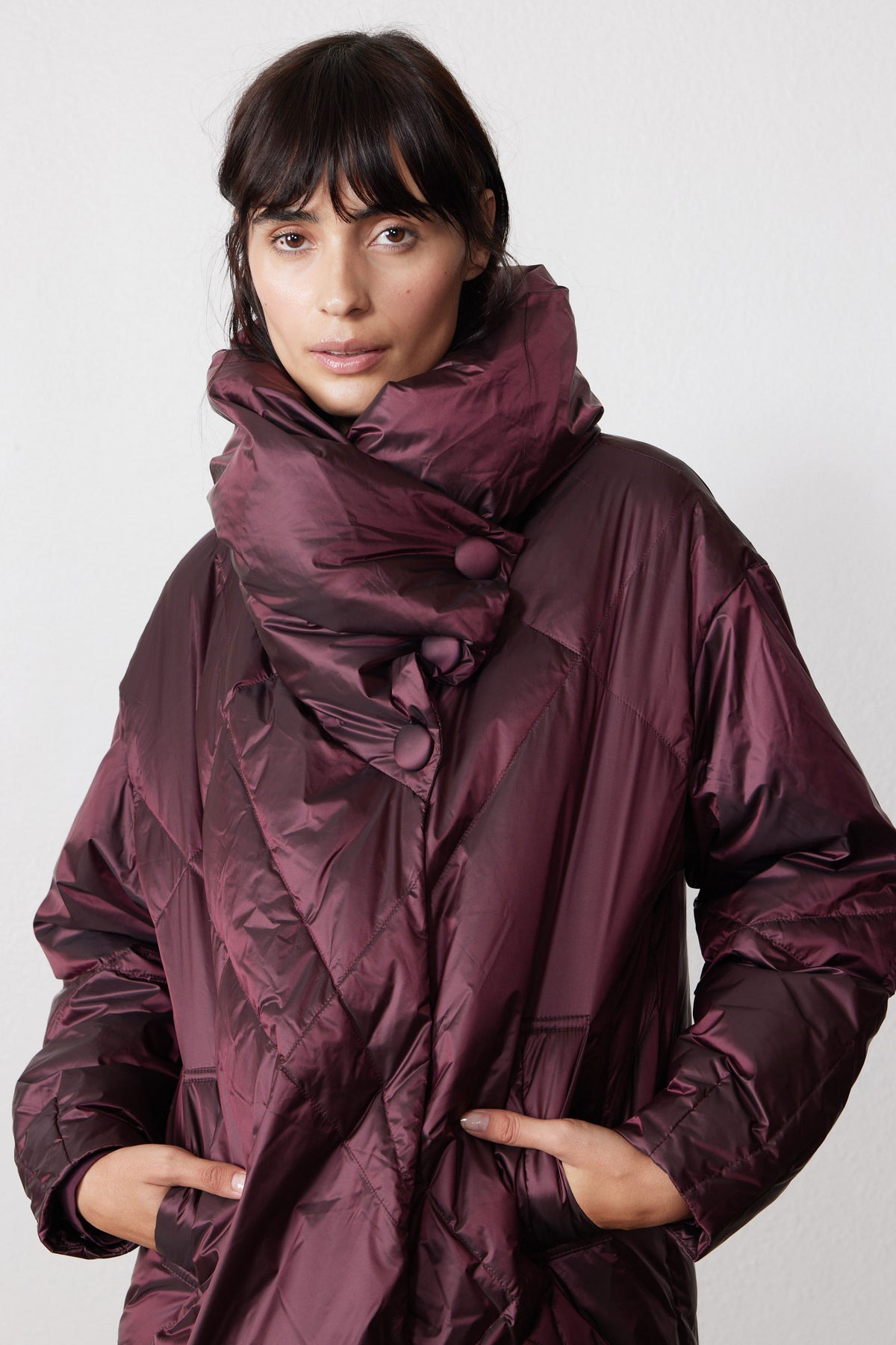 Front view of the mulberry puffer jacket with its collar fastened by snaps