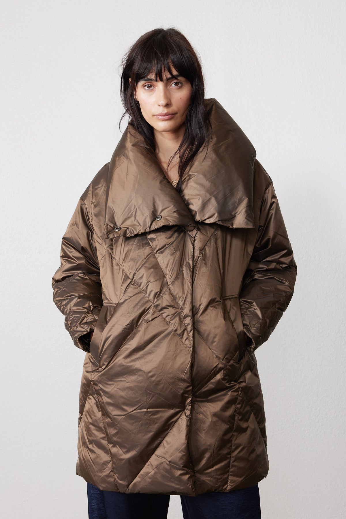 Front view of walnut puffer jacket with oversized collar and angled pockets