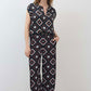 Wide-leg trousers with repeating diamond geometric print on dark base