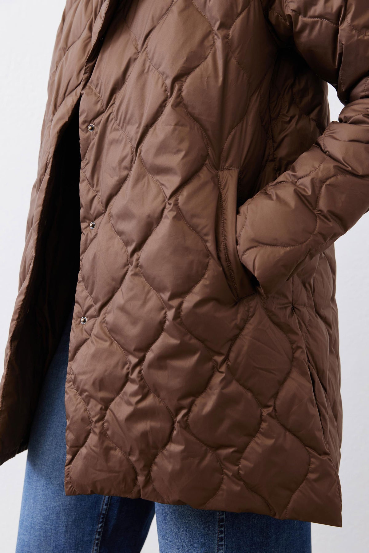 Bistro brown quilted puffer coat front detail with snap buttons and side seam