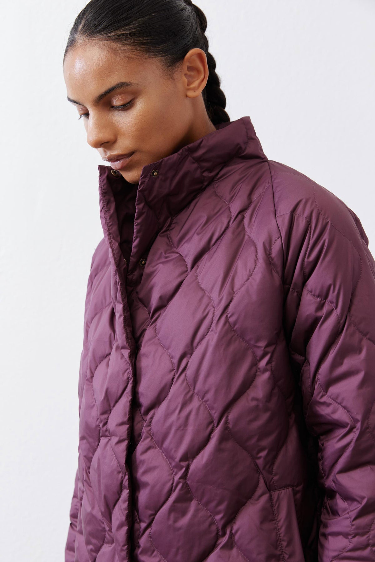 Deep plum quilted down puffer coat close-up of hood and front panels