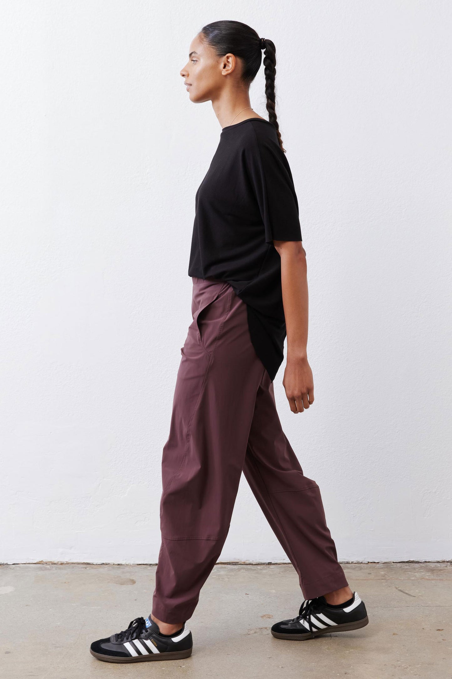 Black short-sleeve top with back button placket and side drape