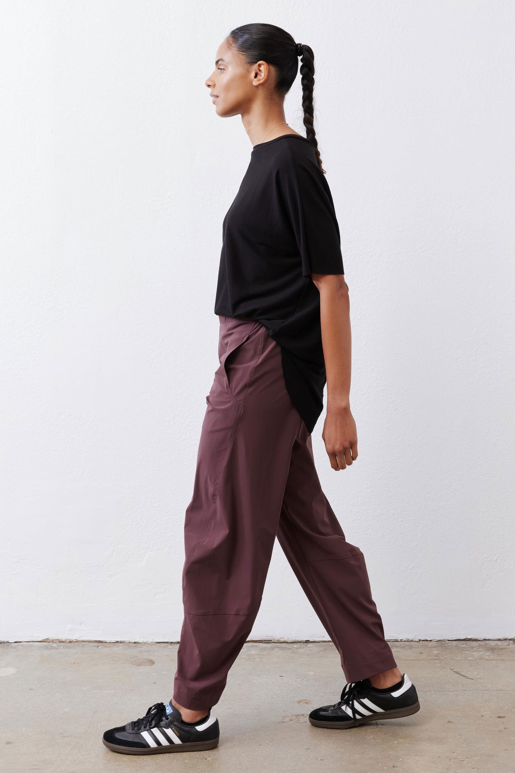 Black short-sleeve top with back button placket and side drape