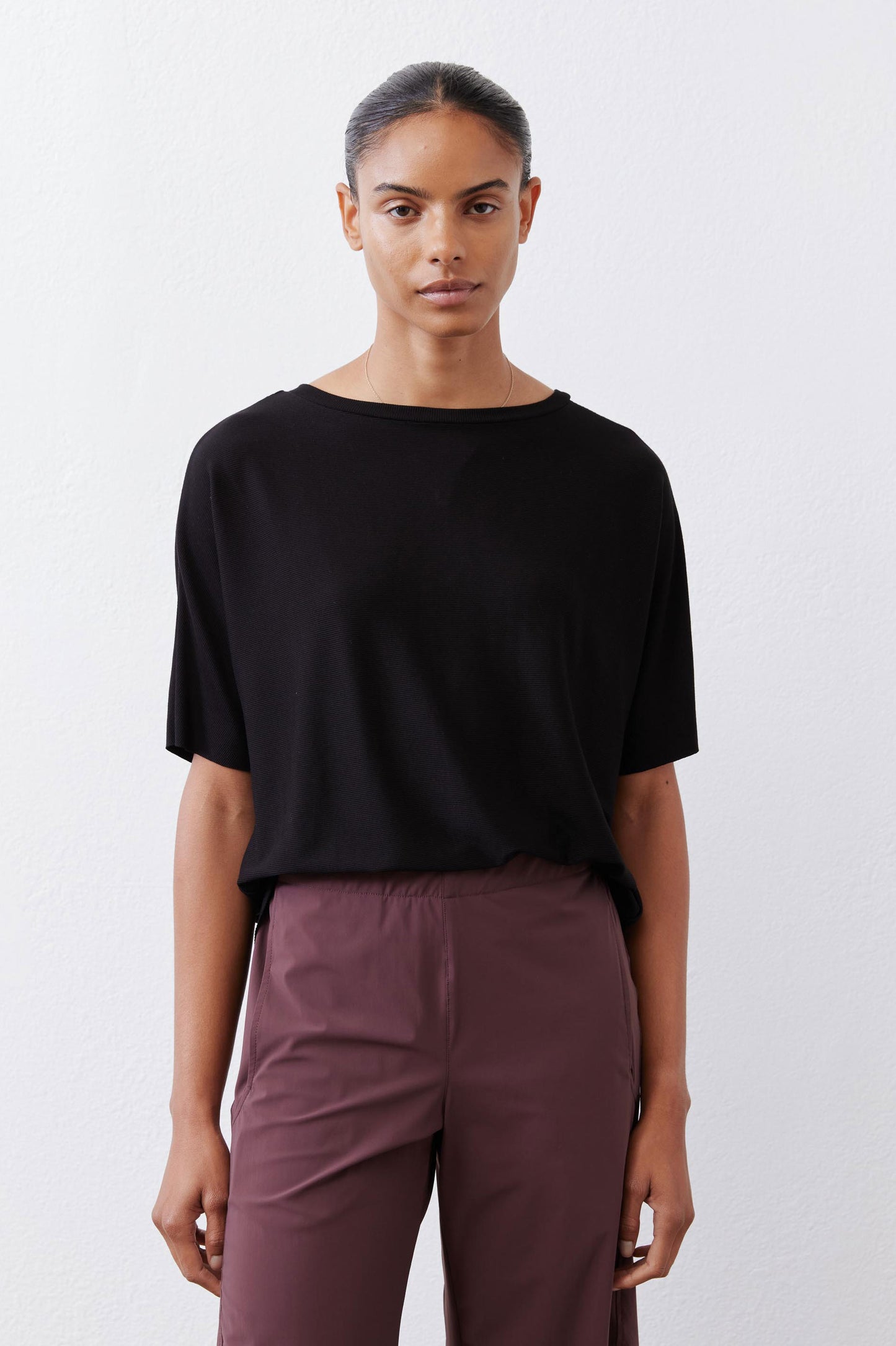 Black short-sleeve crew-neck top with relaxed, straight silhouette