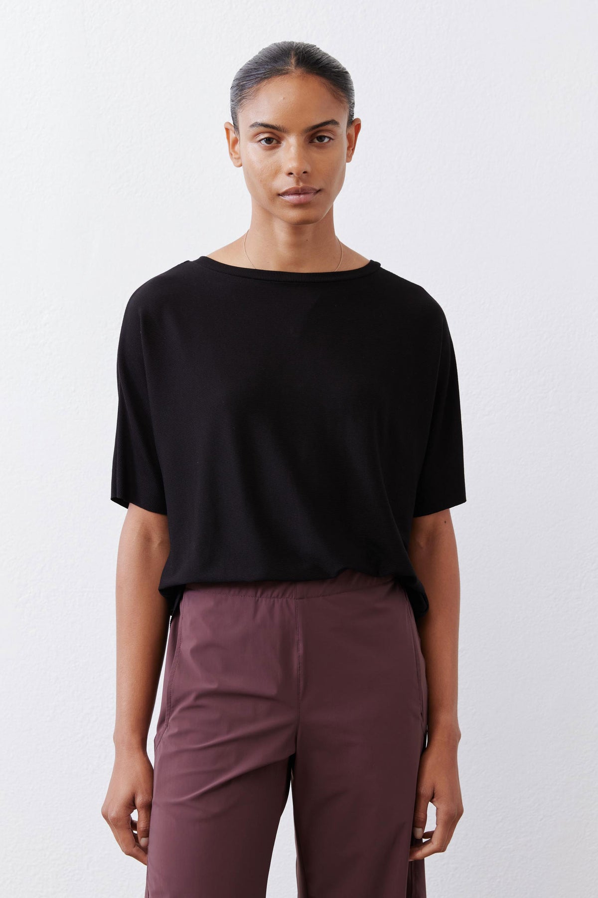 Black short-sleeve crew-neck top with relaxed, straight silhouette