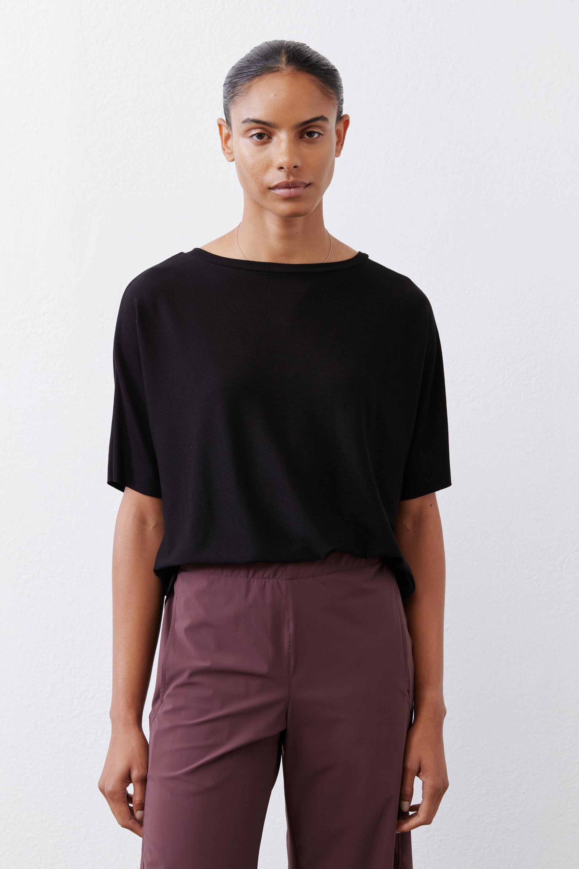 Black short-sleeve crew-neck top with relaxed, straight silhouette