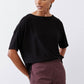 Black short-sleeve crew-neck top with loose fit and minimal seams