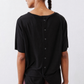 Black short-sleeve button back top with twisted back hem detail