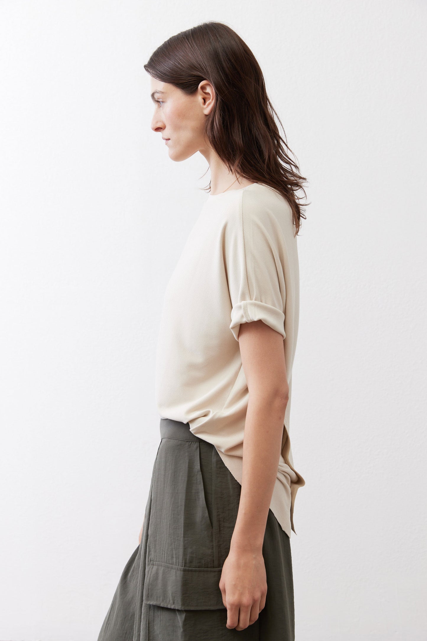Cloud cream short-sleeve top in side view, crew neckline and relaxed hem