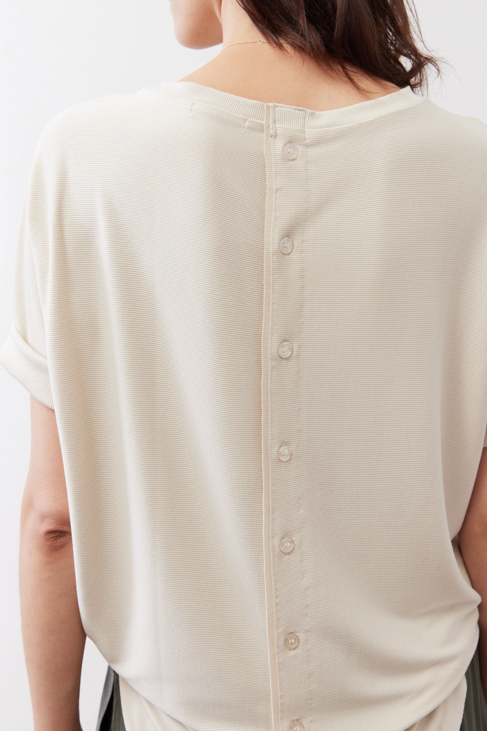 Cloud cream back of top showing vertical button placket and button rows