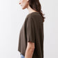 Olive short-sleeve top side view with relaxed drape and loose shoulder
