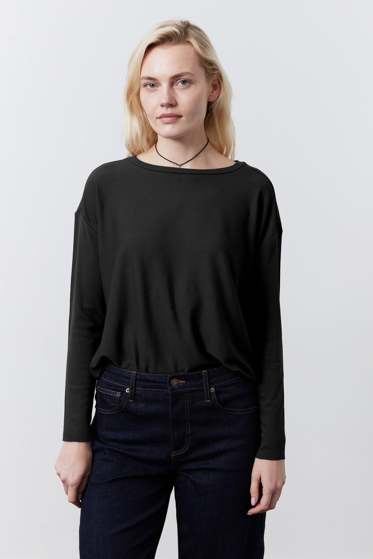 Black long-sleeve essential top with rounded neckline and relaxed fit