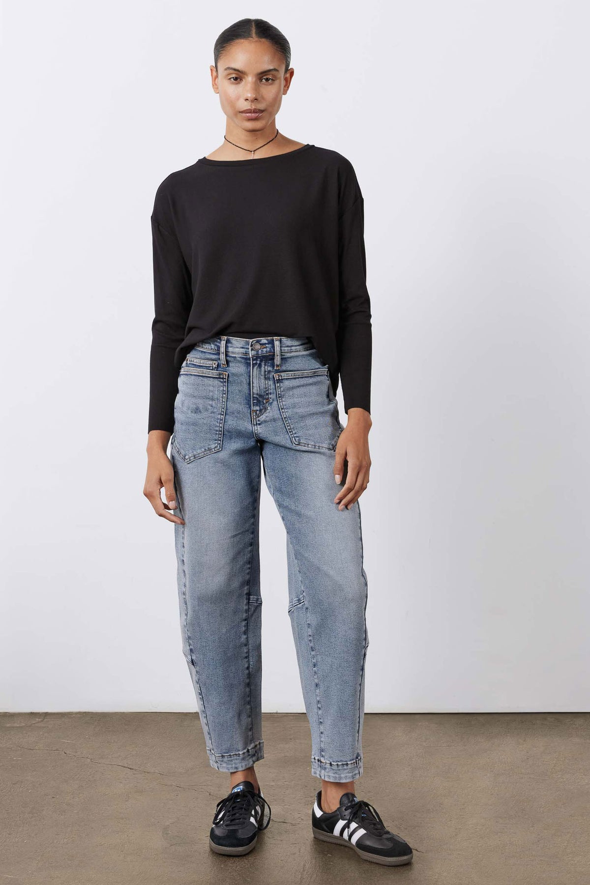Black long-sleeve essential top worn with light wash jeans