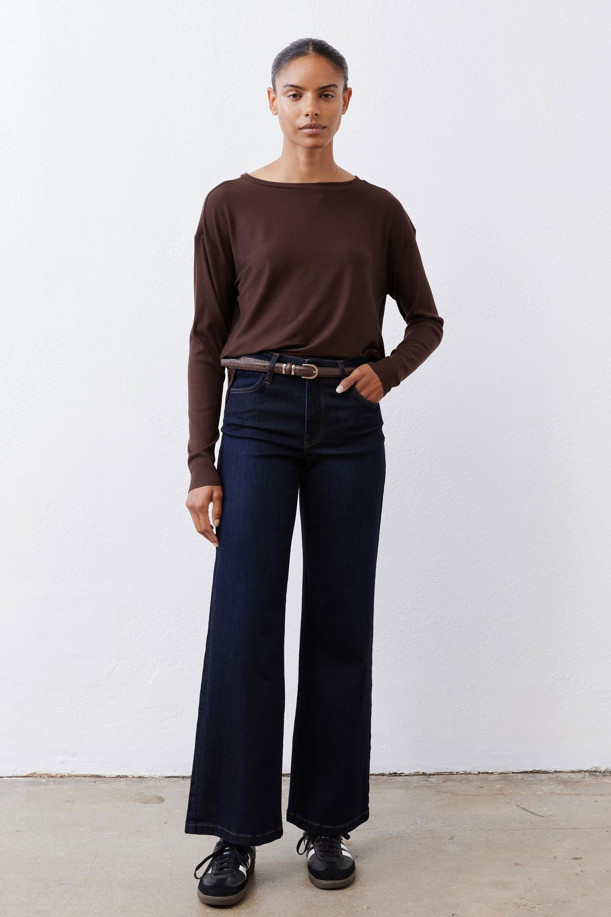 Brown long-sleeve crewneck top with buttoned back detail