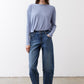 Light blue long-sleeve crewneck top with smooth drape and curved hemline