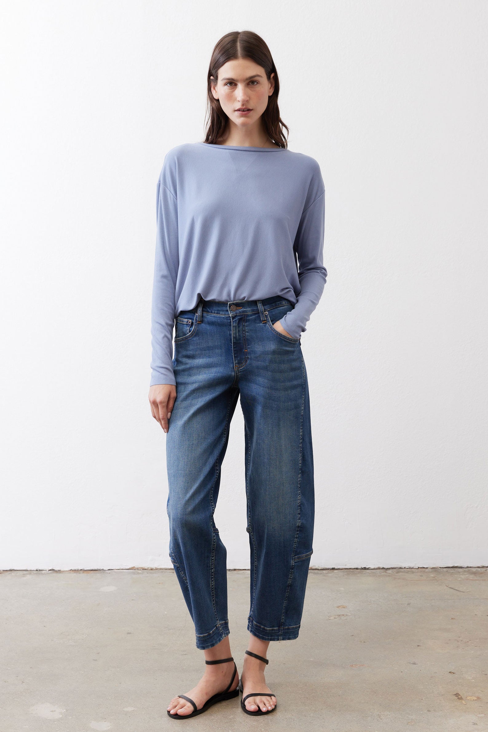 Light blue long-sleeve crewneck top with smooth drape and curved hemline