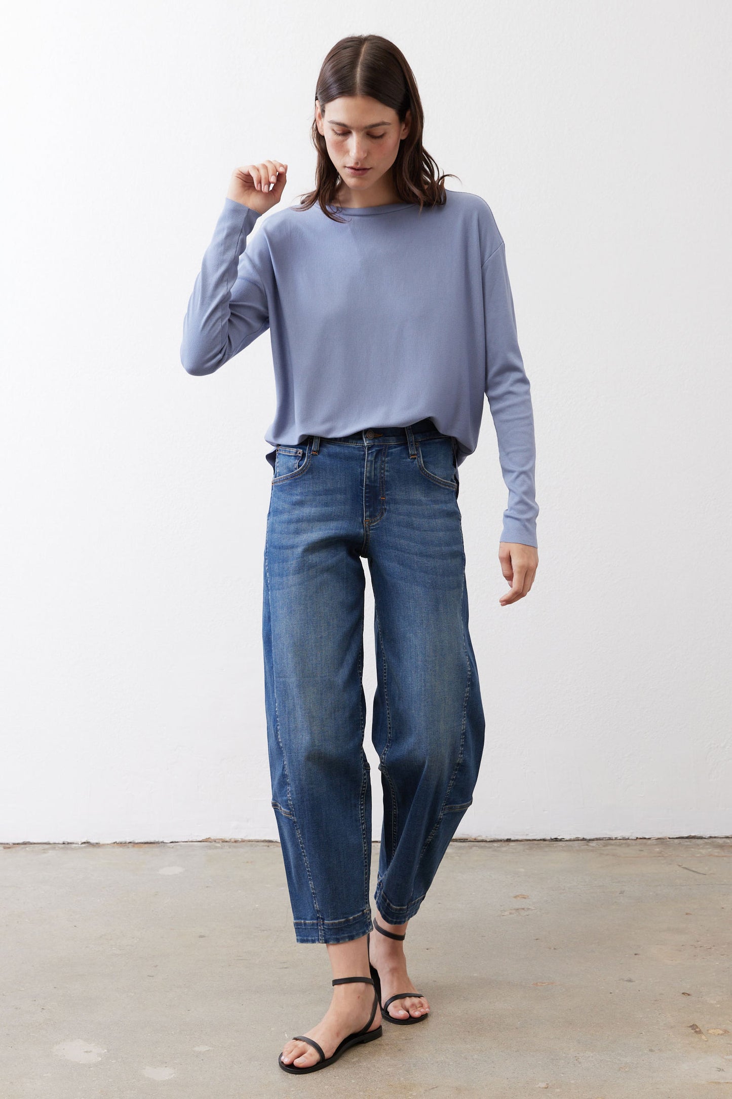 Light blue long-sleeve crewneck top with relaxed fit and curved hem