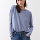 Light blue long-sleeve crewneck top with relaxed fit and dropped shoulders