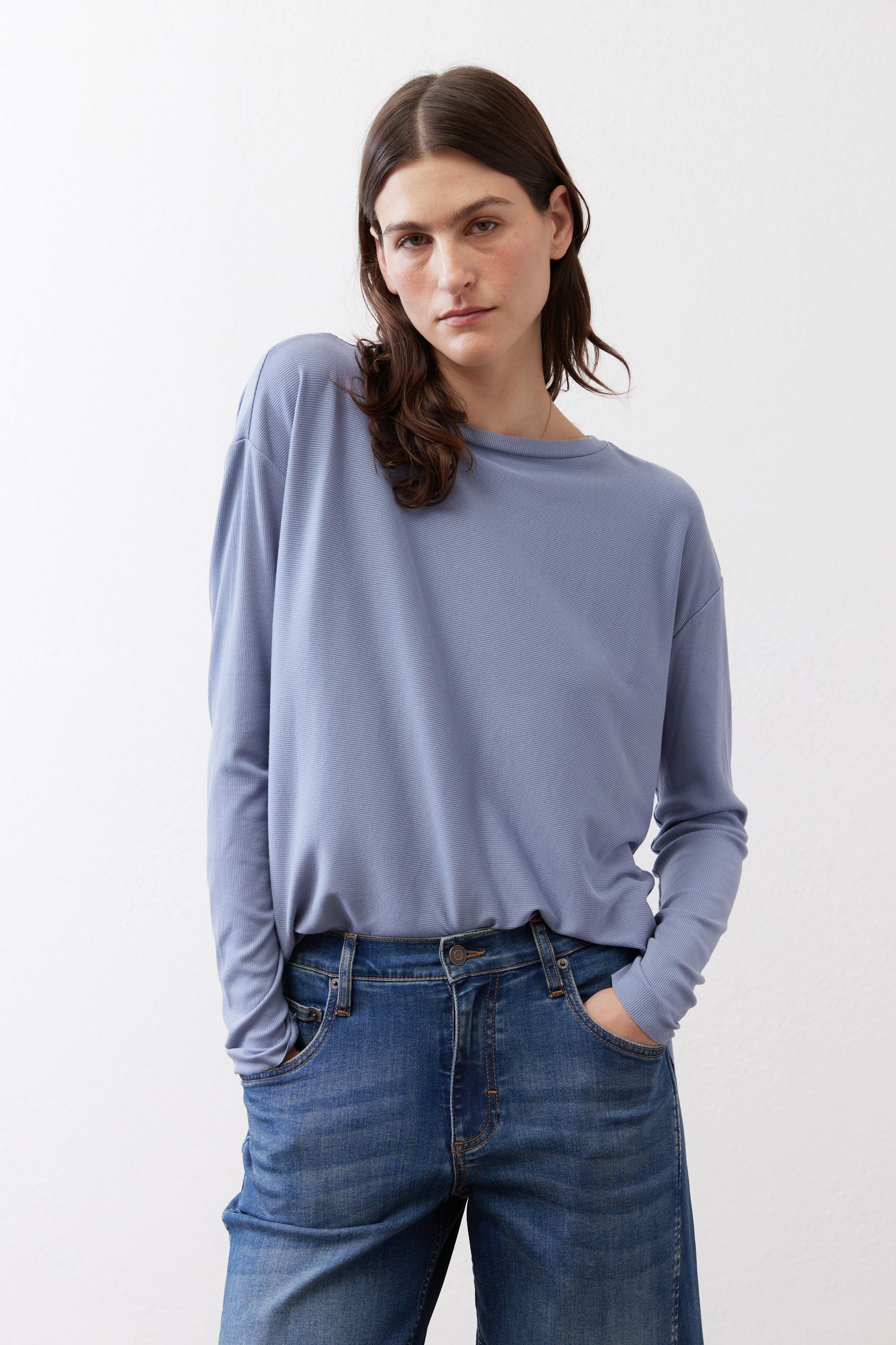 Light blue long-sleeve crewneck top with relaxed fit and dropped shoulders