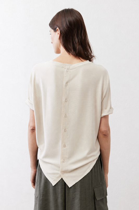 Back view of short-sleeve button top, light cream with center button placket