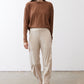 Deep brown long-sleeve top with crew neck, draped fit, front view